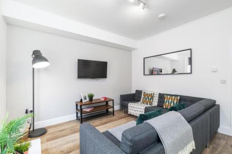 Bright, modern living room with a comfortable L...