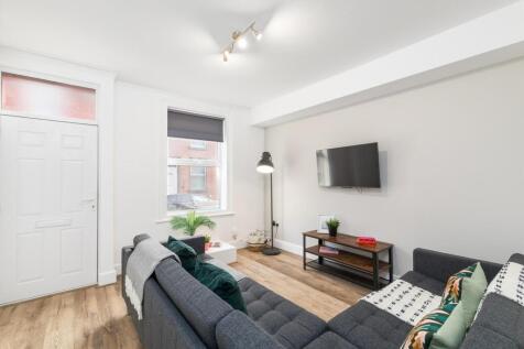 Bright, modern living room with a comfortable L...