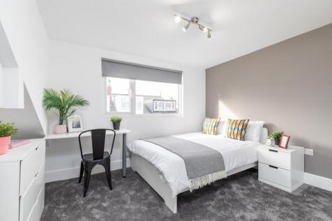 Bright, contemporary double bedroom with a comf...