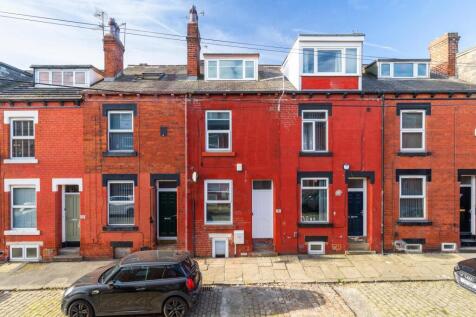 Row of well-maintained red-brick terraced house...