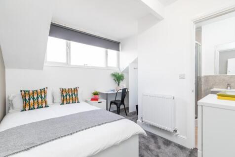 Bright, modern double bedroom with clean white ...