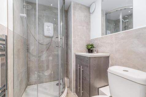 Modern ensuite bathroom with a glass corner sho...