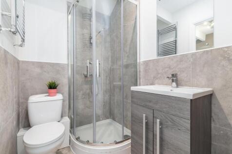 Contemporary bathroom with a corner glass showe...