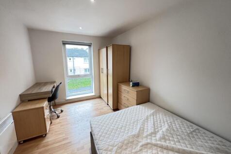 A bright and neatly presented bedroom featuring...