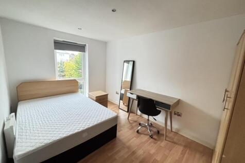 A bright and neat bedroom featuring a comfortab...