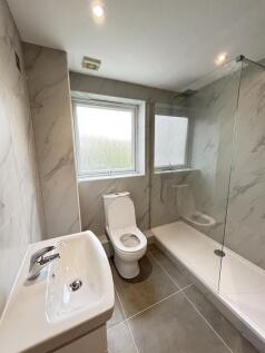 A clean, well-maintained bathroom featuring a t...