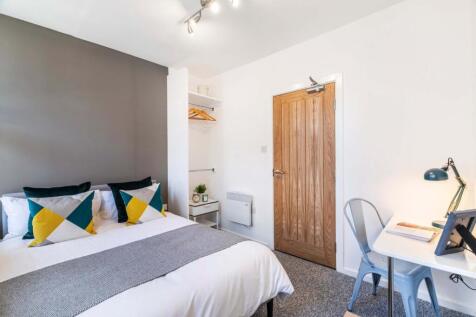 A well-maintained bedroom featuring a double be...