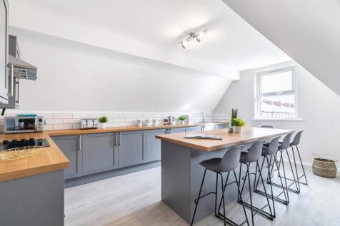 A modern, well-lit kitchen featuring sleek ligh...
