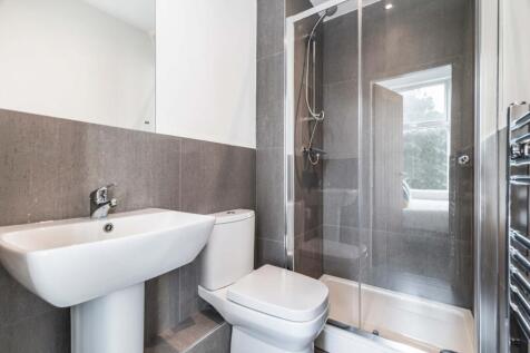Modern bathroom featuring a sleek sink, toilet,...