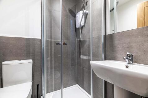 A clean and modern bathroom featuring a shower ...