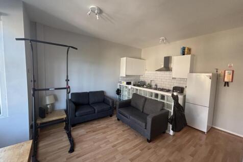 Bright and modern living room featuring a comfo...