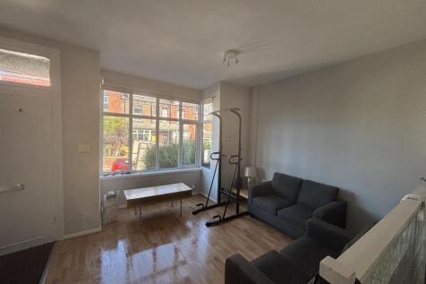 A bright and welcoming living room with large w...