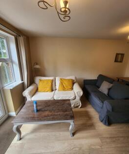 A welcoming living room with two comfortable so...