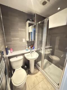 A clean and modern bathroom featuring a shower ...