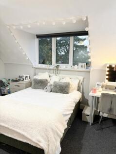 Bright and spacious master bedroom featuring a ...