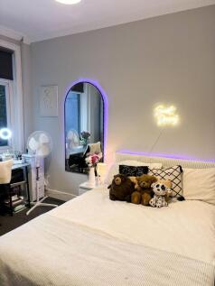 Elegant master bedroom featuring a cozy double ...