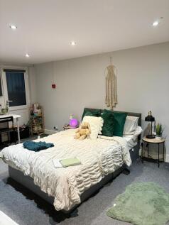 A spacious and inviting master bedroom featurin...