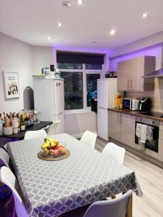 A modern and well-lit kitchen featuring sleek c...