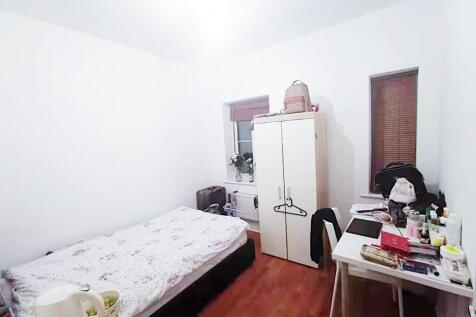 Bright, simply furnished single bedroom with a ...
