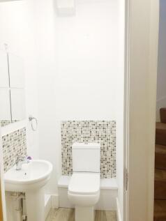 Bright, modern bathroom with a white toilet and...