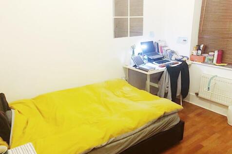 Bright, simply furnished bedroom with a double ...