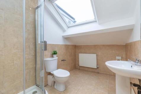 A bright and modern bathroom featuring a shower...