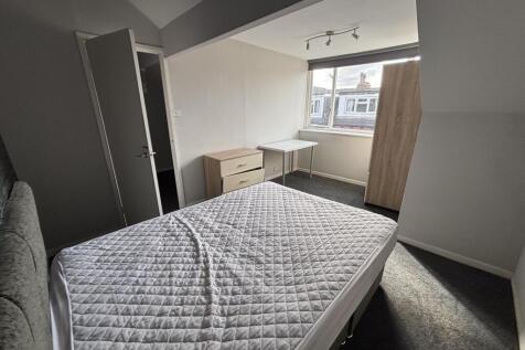 A bright and well-maintained master bedroom fea...