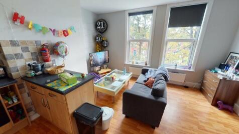A bright and welcoming living room with ample n...