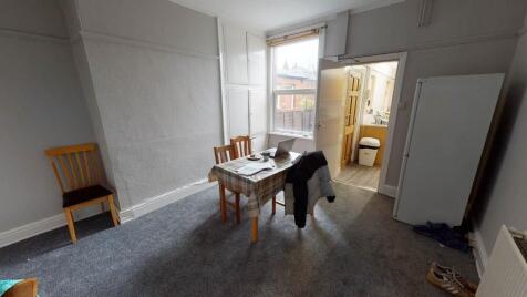 Bright and spacious living room featuring large...