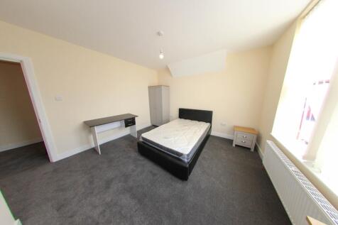 Bright and spacious bedroom featuring a comfort...