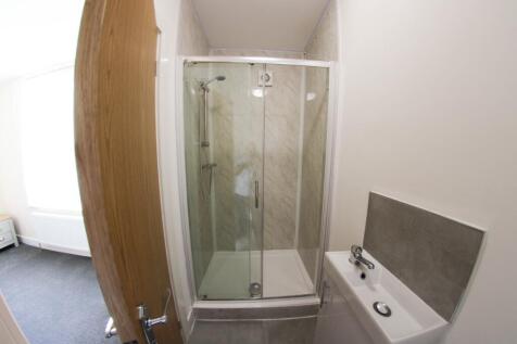 A clean and modern bathroom featuring a spaciou...