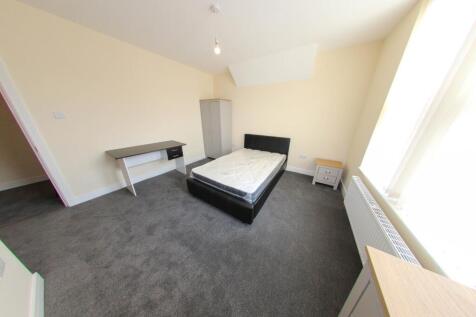 A bright and spacious single bedroom featuring ...