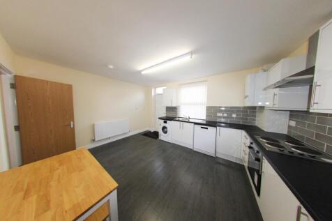 A modern, well-lit kitchen with ample counter s...