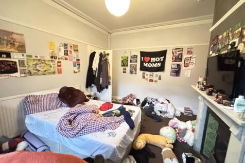 A spacious master bedroom filled with soft natu...