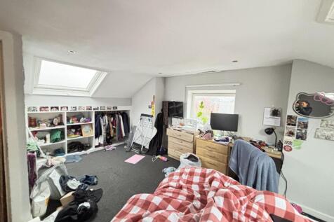 A cozy double bedroom with natural light coming...