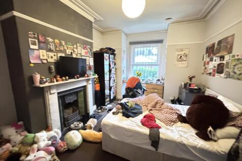 A spacious and lively living room filled with n...