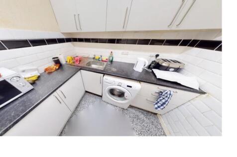 A modern, well-organized kitchen with ample wor...