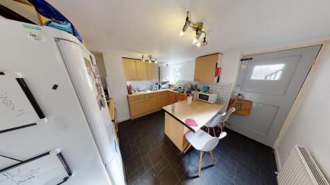 A bright and spacious kitchen area with a comfo...