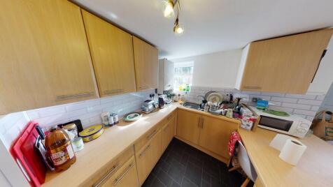 A well-equipped kitchen with ample countertop s...