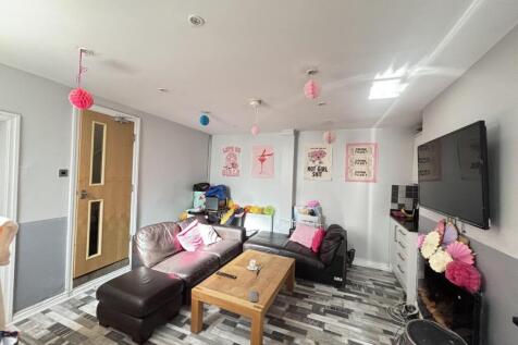 A bright and modern living room featuring a lar...