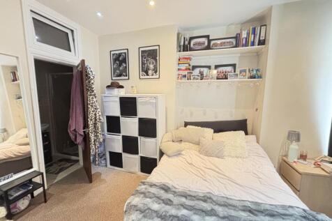 A bright and cozy bedroom featuring a comfortab...