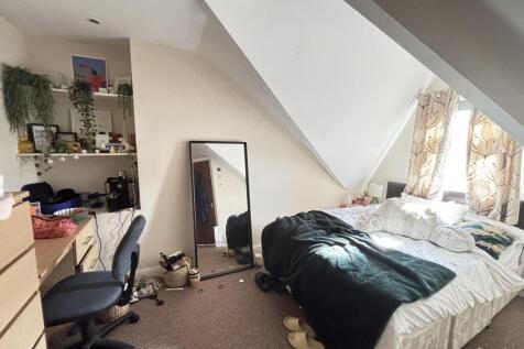 A spacious master bedroom with ample space for ...