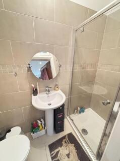 A clean and bright bathroom featuring a spheric...