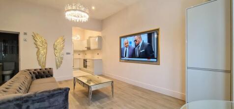 A bright and modern living room featuring a lar...