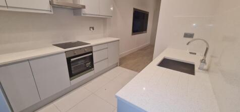 Modern and clean kitchen with sleek cabinetry, ...