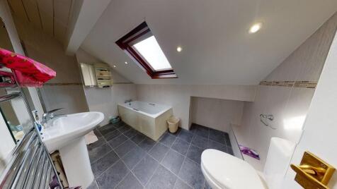 Bright and spacious bathroom with a modern desi...