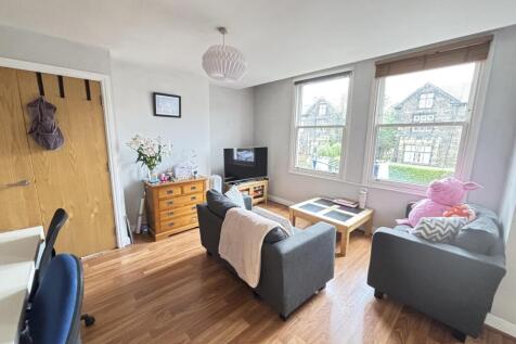 Bright and welcoming living room featuring ampl...