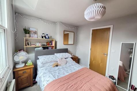 A warm and inviting bedroom featuring a large d...