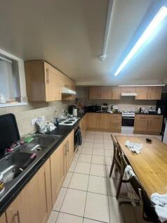 A well-lit, tidy kitchen with ample counter spa...
