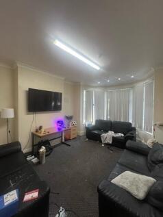 A spacious and comfortable living room featurin...